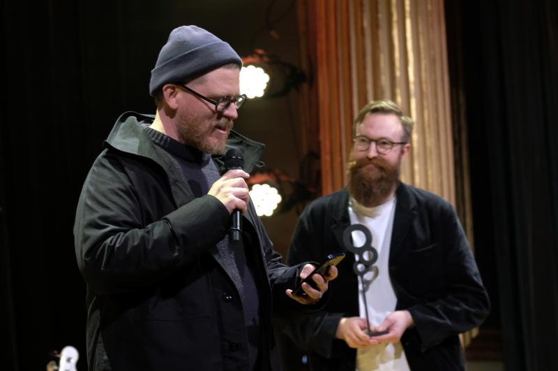 John Chantler tar emot priset å Kali Malones vägnar av FST:s ställföreträdande ordförande Johan Blixt.